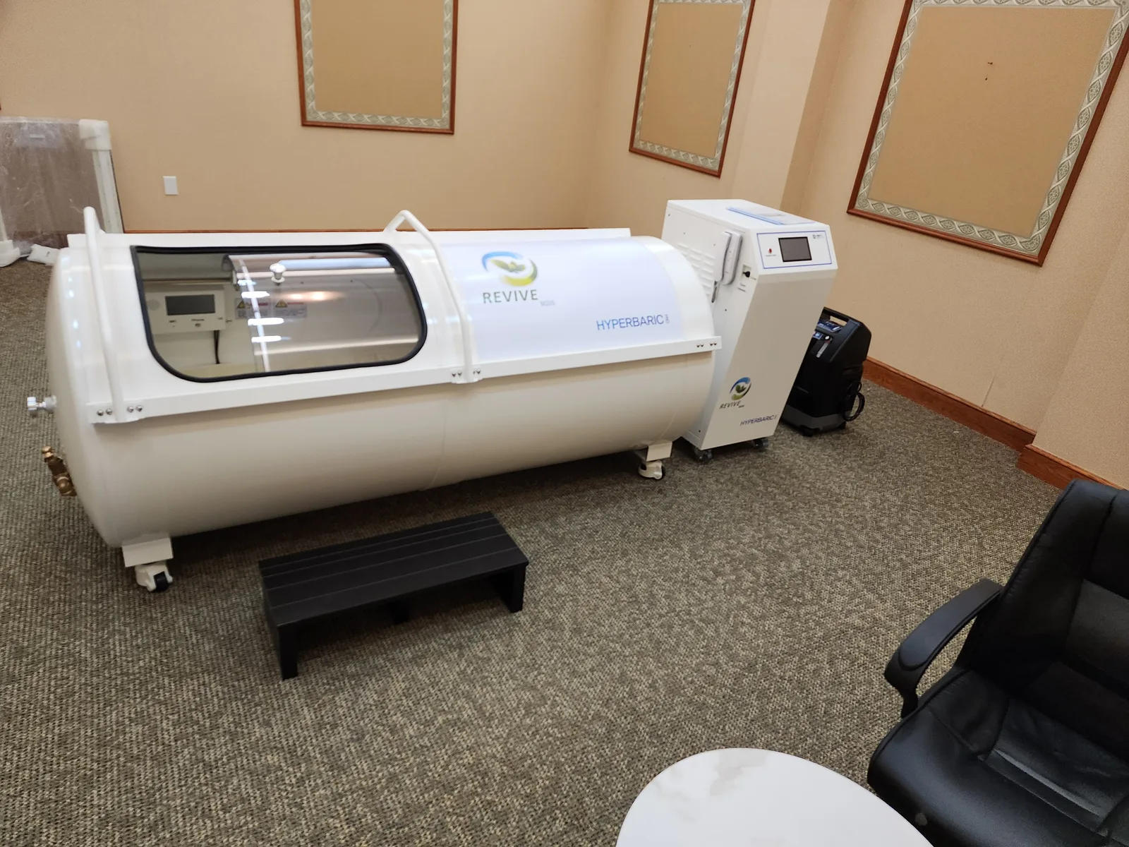 Hyperbaric chamber installed and commissioned in a clinic treatment room.